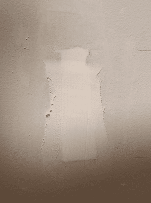 This is the way he left the partially patched hole he put into my wall