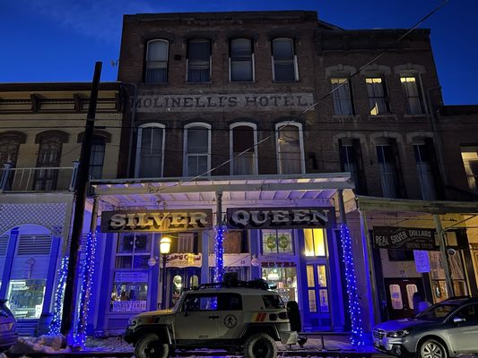 Front of building at night.