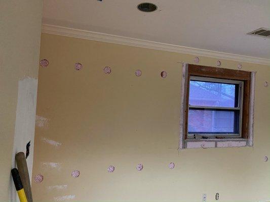 Made holes on wall and filled with blow insulation