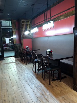 Bright lights and table/booths line one side of the restaurant. Trendy ceramic faux wood plank flooring.