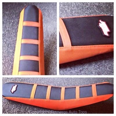 Custom black and orange seat cover for this dirt bike seat by Romero's Auto Tops