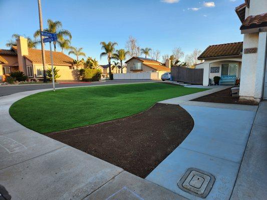 Artificial turf and concrete installed in our front yard to extend the driveway and provide a large amount of play space for the kids