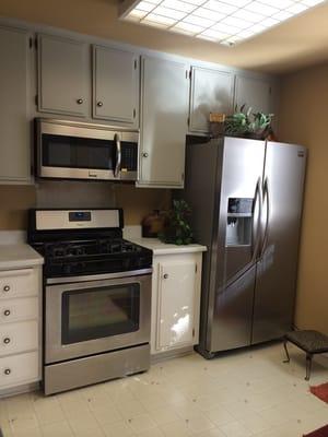 Fridgedaire side-by-side refrigerator at 1/2 off retail, new microwave, gently used stove...can you see any dings? I can't :-)