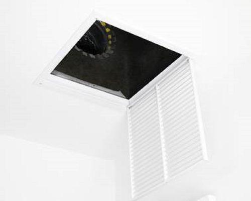 Cleaning vents with compressed air.