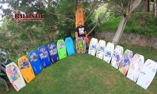 Josh Medeiros with his quiver of Custom Ballistic boards that were 100% hand shaped, hand crafted in Hawaii.  Custom art work.