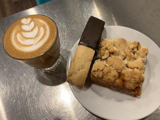 Cortado drink, chocolate dipped biscotti, and apricot almond jam bar.