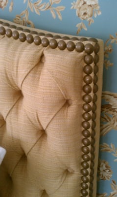 Custom upholstered tufted headboard with decorative nailheads