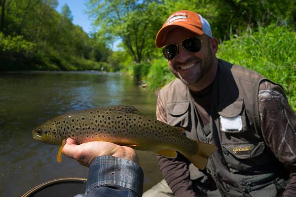 Happy customer fly fishing with one of our guides on the Kinni River!