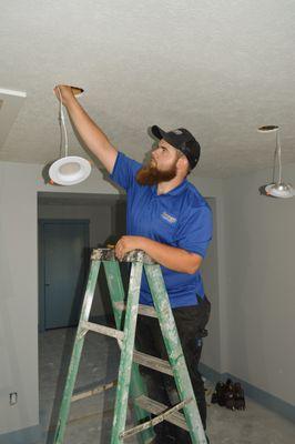 Tech fixing a light fixture