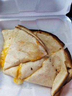 Simple cheese quesadilla thrown in a styrifoam container.