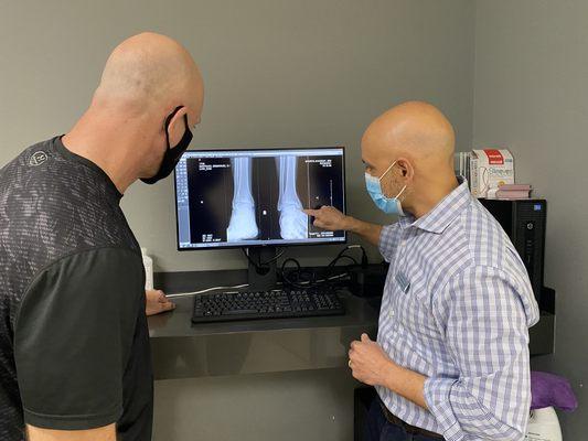 Dr. Robertson reviewing digital X-rays with patient.