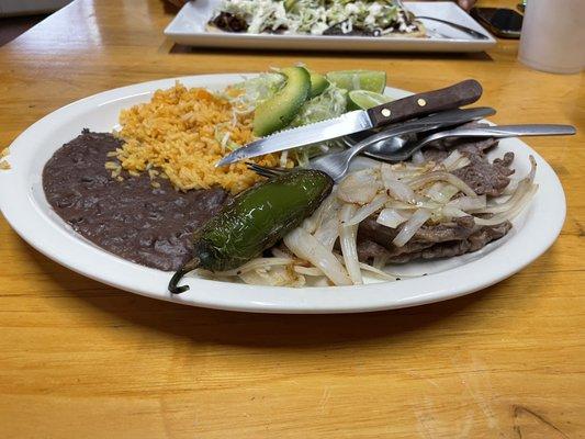 Cecina encebollado with black beans and rice.