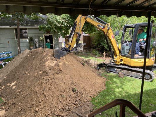 That's A LOT of dirt! Carefully placed on wood sheets to protect the lawn.