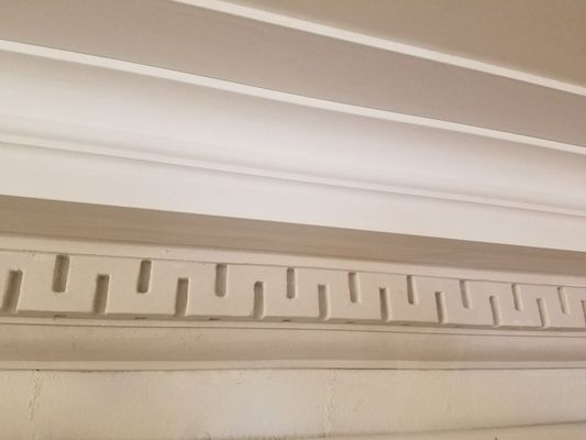 This is a photo of a crown moulding with a Greek Key detail that we totally restored and made 80 feet more for an adjacent space.