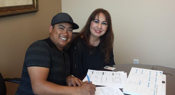 Rolando and family signing loan docs!  One very happy family!