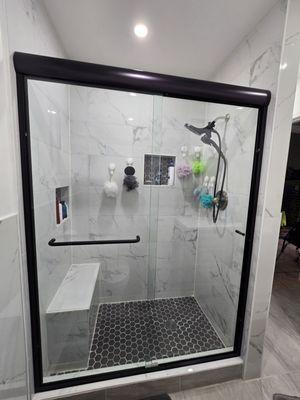 High-quality glass door, black frame, with towel rack handle.