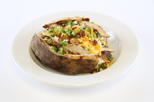 Juicy Grilled Chicken Topped on a Baked Potato served with all the fixings.