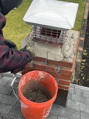 We restored a damaged chimney crown. The flaking chimney crown is patched to replace the missing concrete.