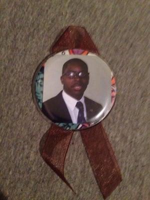 A commemorative button of Cedric Lamont Hamilton.