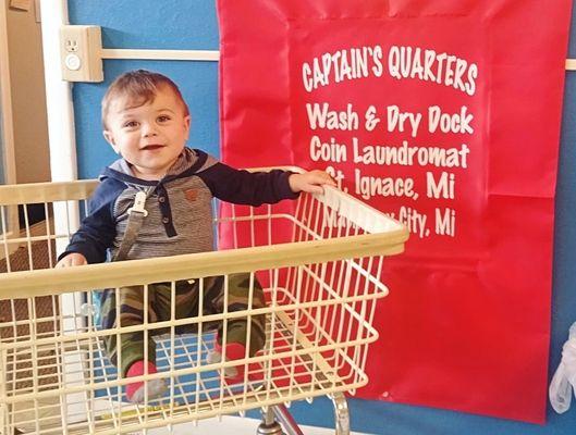 This lil guy is having a great experience at Captains Quarters ll Laundry Mat.