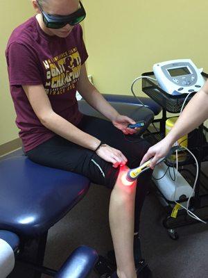 A Lake Hamilton athlete gets cold laser therapy on her knee.