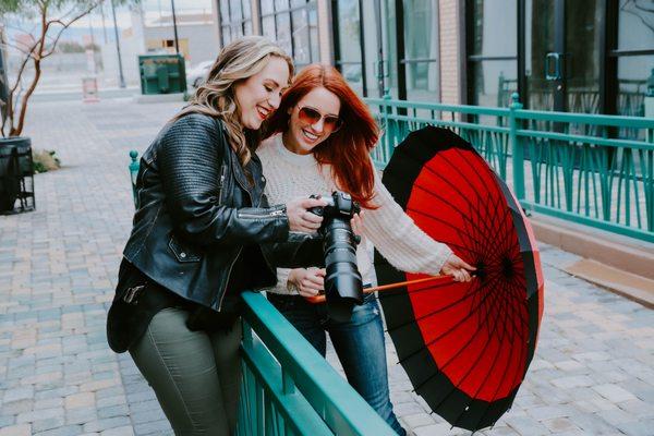 Casey and Megan showing off images from their shoot