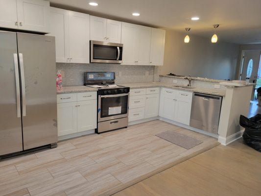 New kitchen shaker style cabinets, tile flooring and backslash. Granite counter tops. Recessed and pendant lighting.