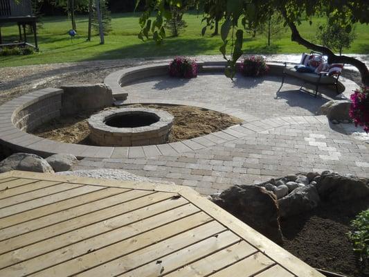 Patio, walkway and fire pit with deck addition.