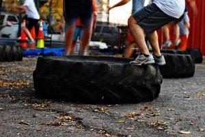 Power F.I.T. Boot Camp class members performing tire jumps in a warm up.