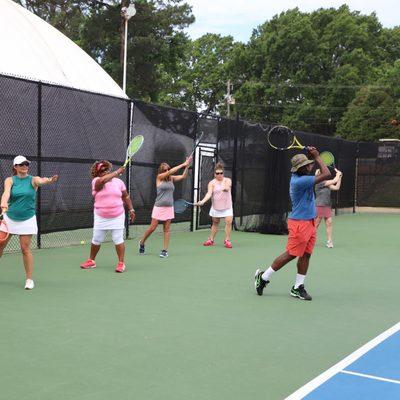 Coach Gio doing a  forehand Demo with the beginner women's clinic