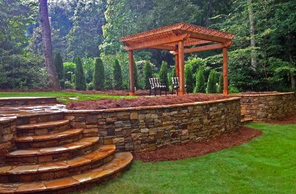 Stone Retaining Wall and Stairs with Outdoor Landscape Lighting and Pergola with Stone Patio