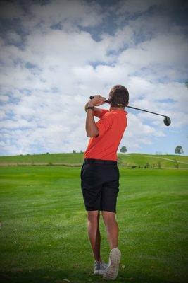 Male golfer on golf course.