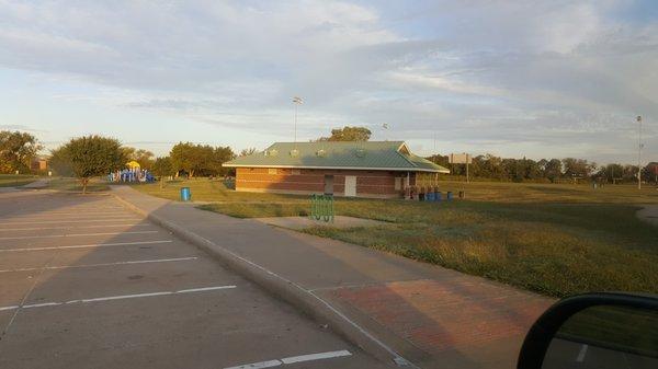 Restrooms/snack building & outdoor gym equipment behind it.