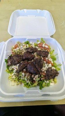 Greek salad with added lamb kabob skewer. good amount of meat.  Good dressing