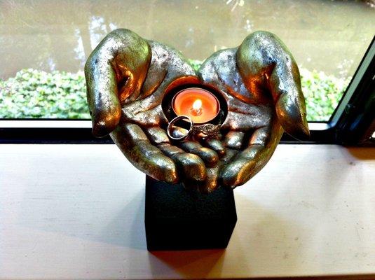 Hands candle holder in chapel window