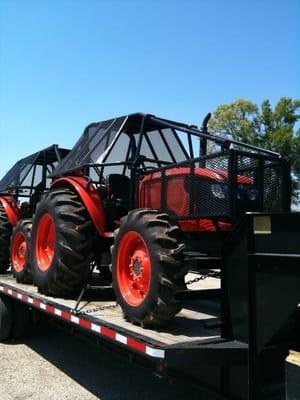 Some of our four wheel drive tractor fleet with brush cages for clearing using Brown Tree Cutters