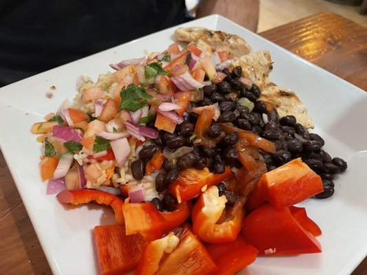 Protein plate with grilled chicken, black beans, some bell peppers, salsa and brown rice.