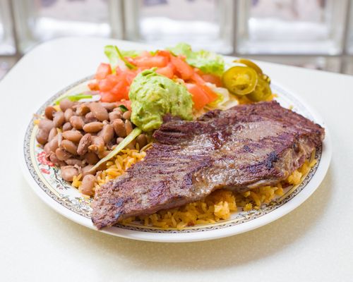 Steak Rice Plate comes with rice, beans, lettuce, and pico de gallo. Guacamole is extra charge.