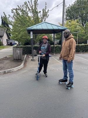 Family skating in an empty parking lot.