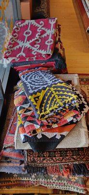 Some patchwork pieces as well as woven rugs.