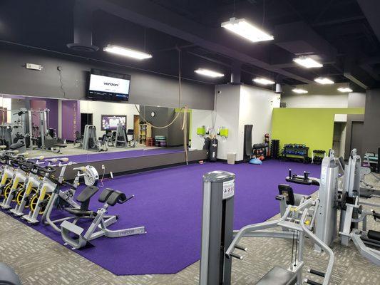 Newly remodeled dynamic space with purple turf, heavy bag, and climbing rope.