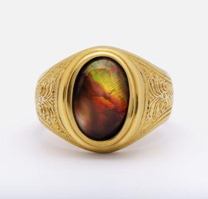 Identified as natural Australian opal weighing an estimated 4cts. Men's ring in 18k gold. Photo by Chris James