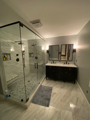 Custom bathroom with new dual sink vanity and built in shower bench.