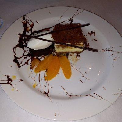 Tiramisu with orange garnish.