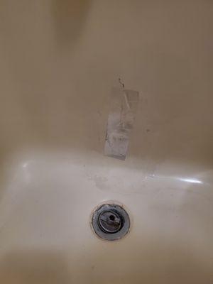 Duct tape over hole in tub.