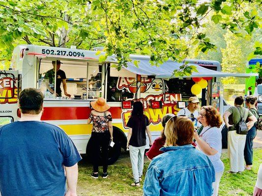 Customers ordering at Acme Chicken Bowls Food Truck