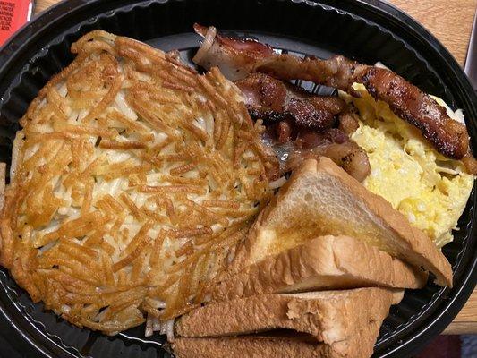 Hash browns with bacon, scrambled eggs, and toast