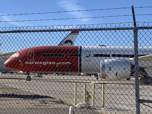 In between buildings. There are so many little areas to view the stored planes. Just drive around and stay behind the fence. Lol.