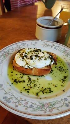 Amazing breakfast.  Poached eggs,served over toasted garlic bread & topped with parmisian cheese &  pesto butter sauce. YUMMERS!