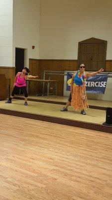 One of our Waikiki students dancing on stage with Instructor Sheri for a point on her Beach Body Bingo card